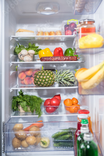 Open fridge full of fresh groceries