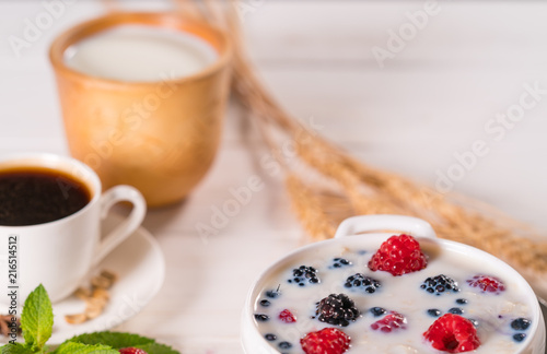 Bowl of breakfast cereal with milk and berries