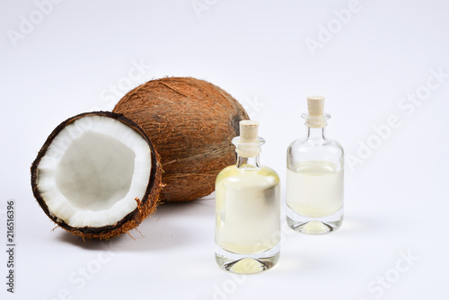 Natural coconut oil in bottles on white background.