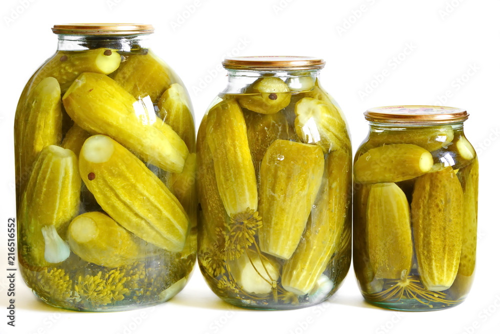 Three closed glass jar of different volume with marinated green pickles in brine and spices: garlic, dill, peas black hot pepper. Isolated. White background Three closed glass jar of different volume with marinated green pickles in brine and spices: garlic, dill, peas black hot pepper. Isolated. White background
