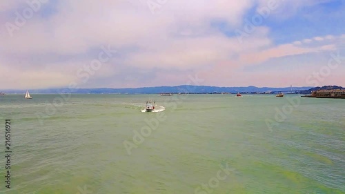 Small fishing boat returning in San Francisco Bay area. photo