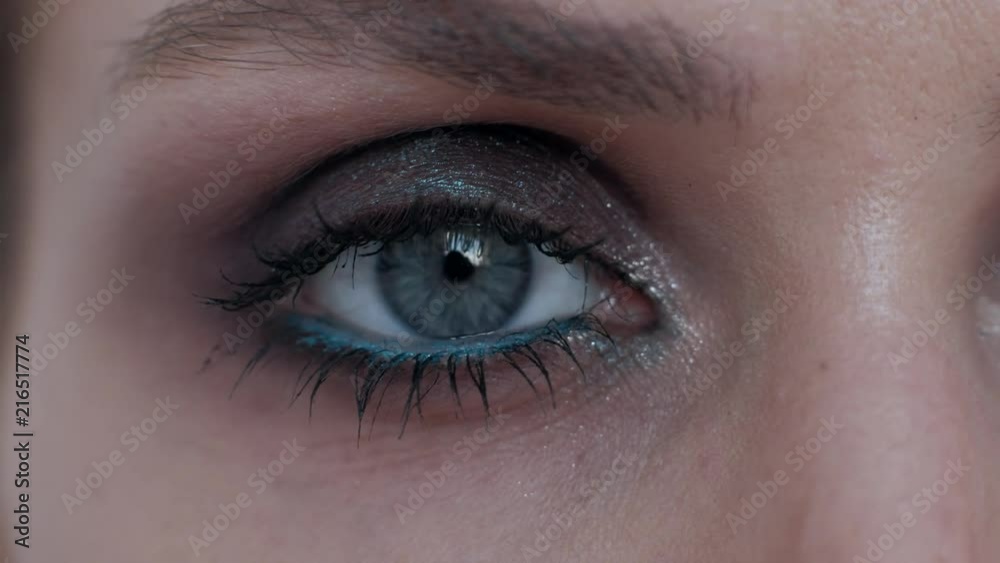 close up - female opening her blue eye, blinking eye beautiful woman with a bright makeup, looking at camera, happy eyesight optical concept, beauty shot close up - female opening her blue eye, blinking eye beautiful woman with a bright makeup, looking at camera, happy eyesight optical concept, beauty shot