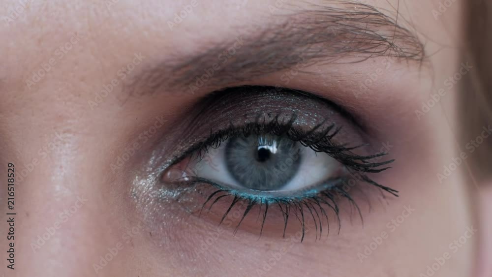 close up - female opening her blue eye, blinking eye beautiful woman with a bright makeup, looking at camera, happy eyesight optical concept, beauty shot close up - female opening her blue eye, blinking eye beautiful woman with a bright makeup, looking at camera, happy eyesight optical concept, beauty shot