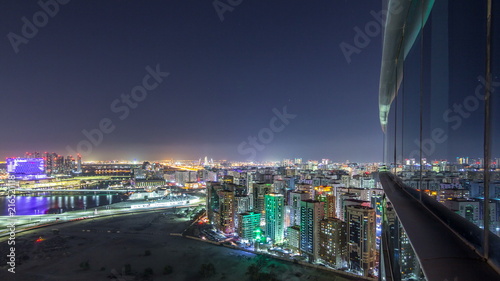 Aerial skyline of Abu Dhabi city centre from above night timelapse photo