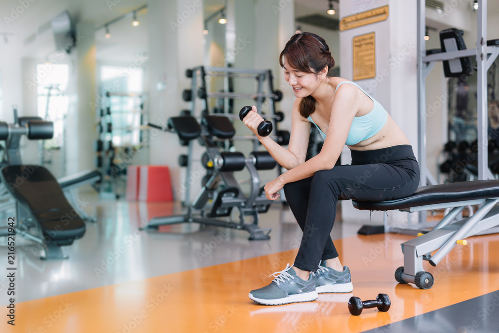 Women exercise in weight lifting with Dumbbell is a sport to build strong muscles.
