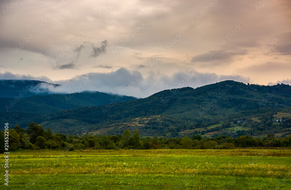 dawn in mountainous countryside. clouds rising above the hills. lovely autumn landscape dawn in mountainous countryside. clouds rising above the hills. lovely autumn landscape