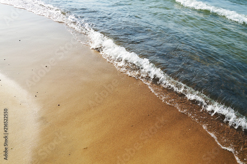 Sandy sea beach and sea waves
