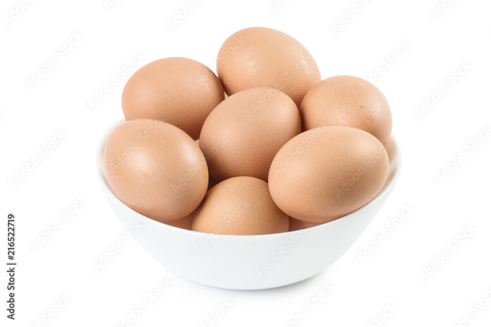 White plate full of brown eggs, isolated on white background White plate full of brown eggs, isolated on white background