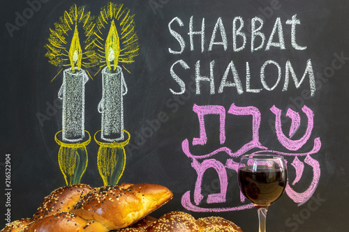Obraz na płótnie Jewish greetings Shabbat Shalom and candles painted on a chalkboard. May you dwell in completeness on this seventh day. Challah and glass of wine. w salonie