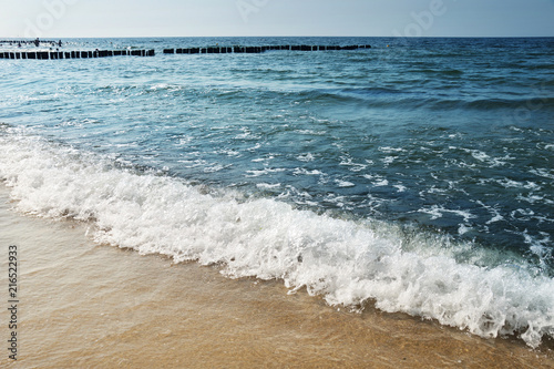 Sandy sea beach and sea waves