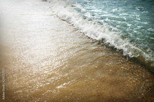 Sandy sea beach and sea waves