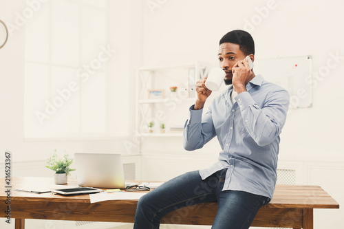 Young black businessman has mobile phone talk