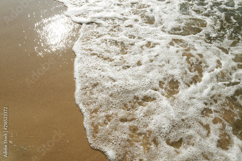 Sandy sea beach and sea waves