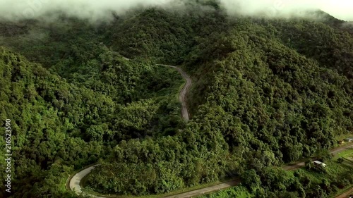 Aerial view of a pick up truck driving on the countryside road surrounded by the beautiful Doi Phuka mountain forrest in Nan Province Northern Thailand photo