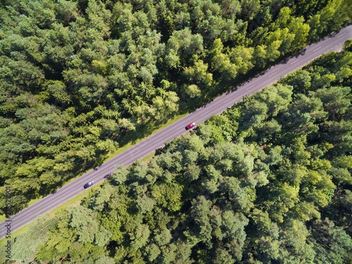 Aerial view of straight road through the mixed forest, Mazury, Poland