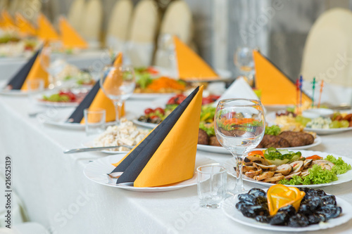 banquet hall of the restaurant, beautifully decorated tables with food 