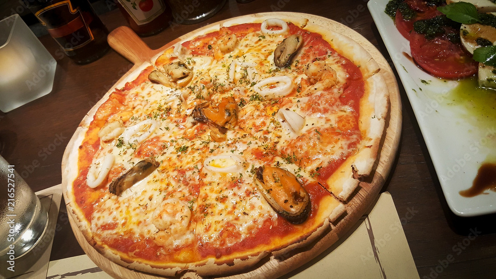 seafood pizza on table wood backgrounds seafood pizza on table wood backgrounds