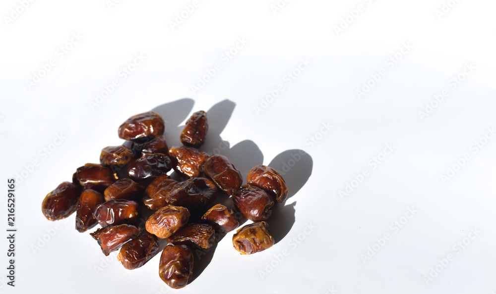 Obraz premium dried dates isolated on white background. selective focus.