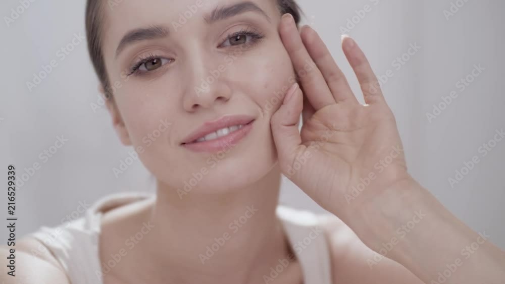 Beauty Face Closeup. Woman Touching Skin And Smiling Beauty Face Closeup. Woman Touching Skin And Smiling