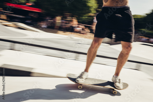 Lower part of a motion blurred male skateboarder 