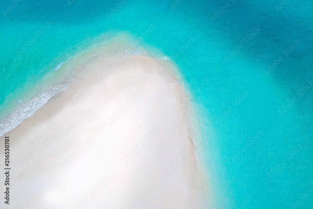 White sand bank and turquoise ocean from above