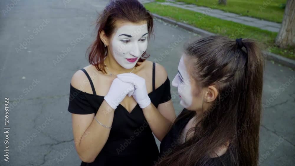 Two girls mimes imitate embarrassment when see camera Two girls mimes imitate embarrassment when see camera