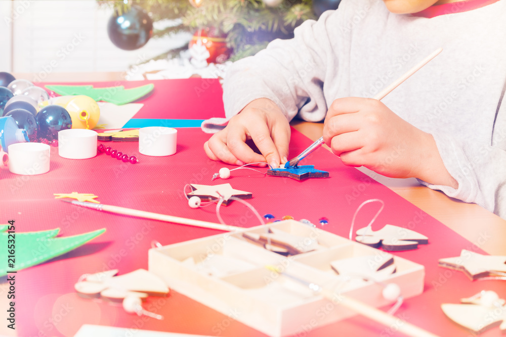 Closeup kids hand making x-mass presents Closeup kids hand making x-mass presents