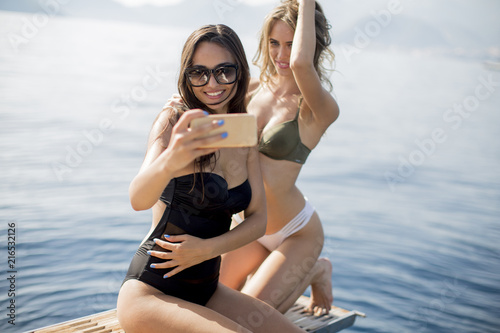 Two pretty young women taki...