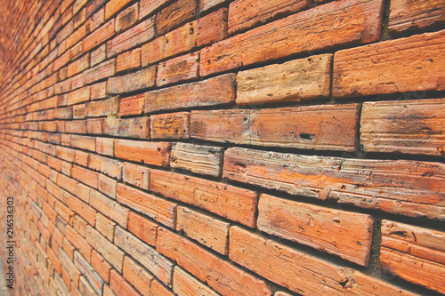 Ancient block wall with brown and orange tone, Side or Oblique view, Old square pattern, Texture background.