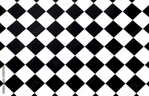 Black and white checkered floor tiles seamlessly as a pattern, top view