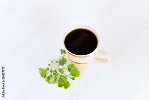a cup of coffee with tropical flowers isolated on white background. selective focus.