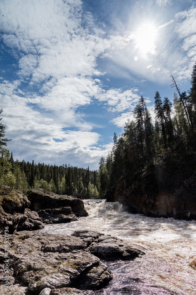 River in Finland Lappland with some blue sky and trees River in Finland Lappland with some blue sky and trees