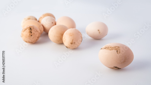 Group of dirty chicken eggs on gray background, banner 16x9