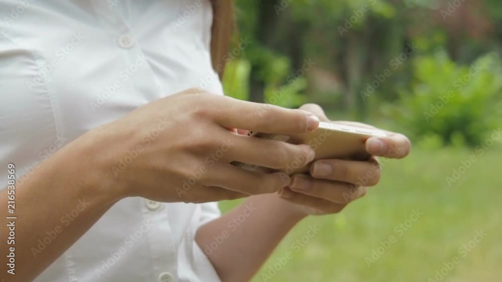 Mobile phone close-up in the hands of a girl. A girl is playing in a gadget. Games on the Internet. Mobile phone close-up in the hands of a girl. A girl is playing in a gadget. Games on the Internet.