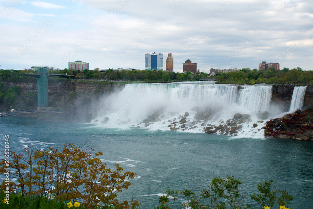 NIAGARA FALLS, ONTARIO, CANADA - MAY 20th 2018: View of the American Falls is the second-largest of the three waterfalls that together are known as Niagara Falls on the Niagara River along the Canada NIAGARA FALLS, ONTARIO, CANADA - MAY 20th 2018: View of the American Falls is the second-largest of the three waterfalls that together are known as Niagara Falls on the Niagara River along the Canada