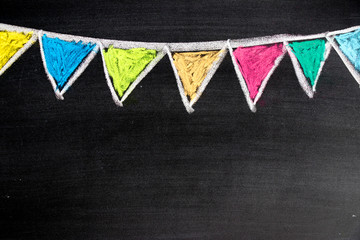 Colorful chalk drawing in hanging party flag shape on blackboard background