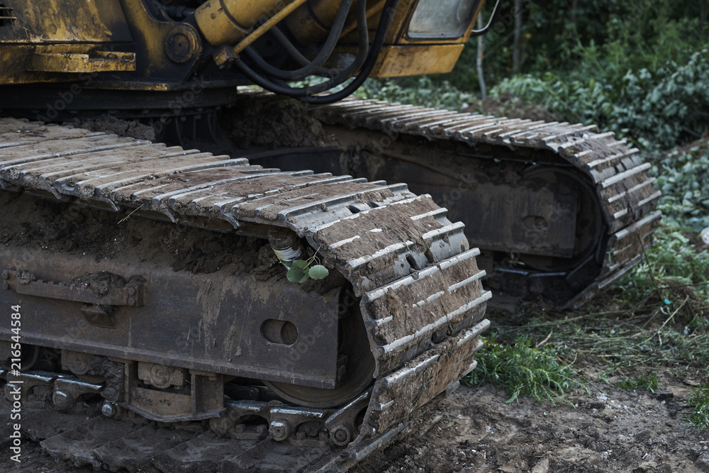 dirty tracks of old excavator close up