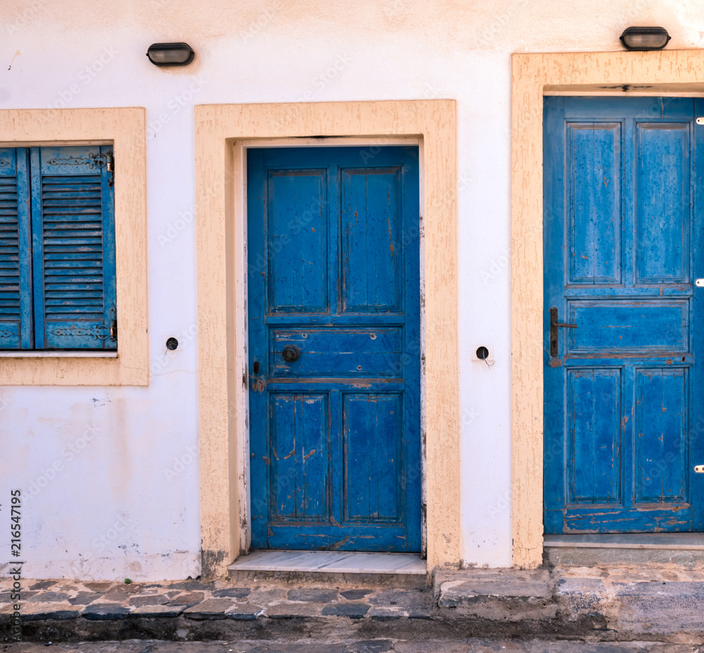 Blue doors and window with closed shutters - Greece, Crete.