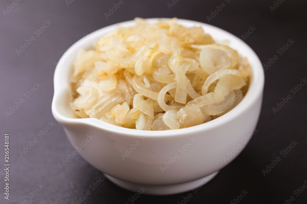 Homemade caramelized onions in frying pan. Vegetarian food..