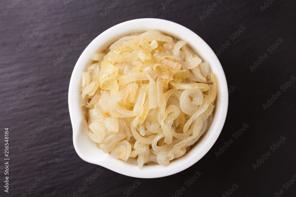 Homemade caramelized onions in frying pan. Vegetarian food.. Homemade caramelized onions in frying pan. Vegetarian food..
