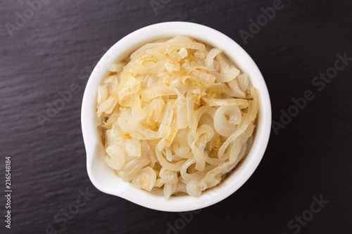 Tableau sur toile Homemade caramelized onions in frying pan. Vegetarian food..
