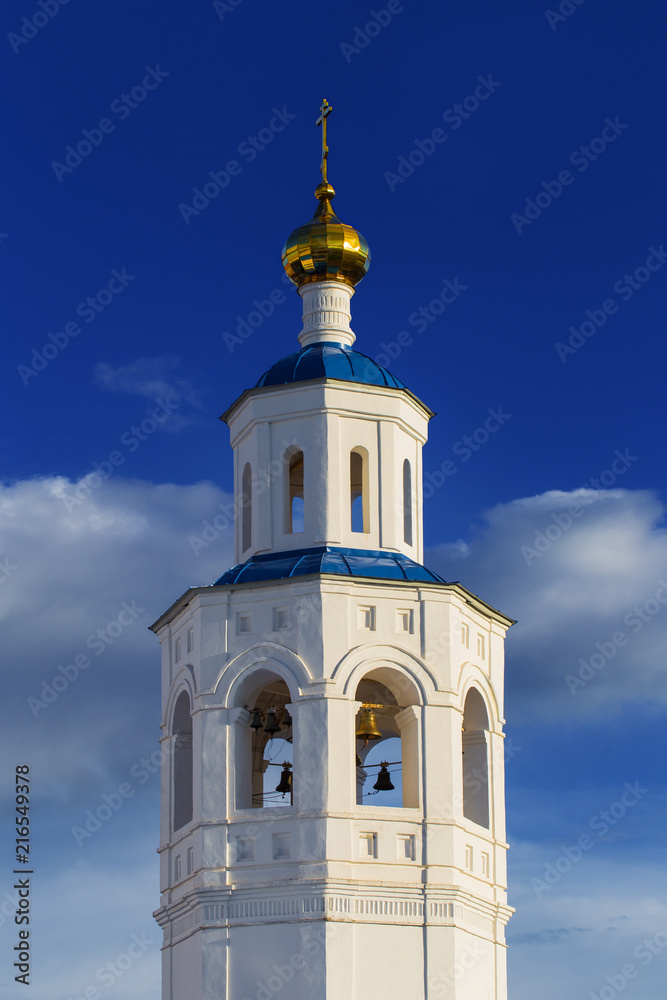 Russian white church steeple on a blue sky Russian white church steeple on a blue sky