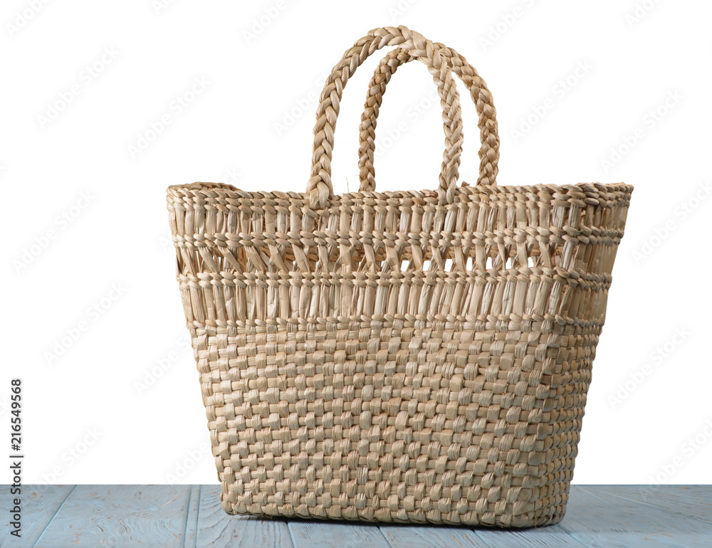 Straw bag on the table with isolated background Straw bag on the table with isolated background