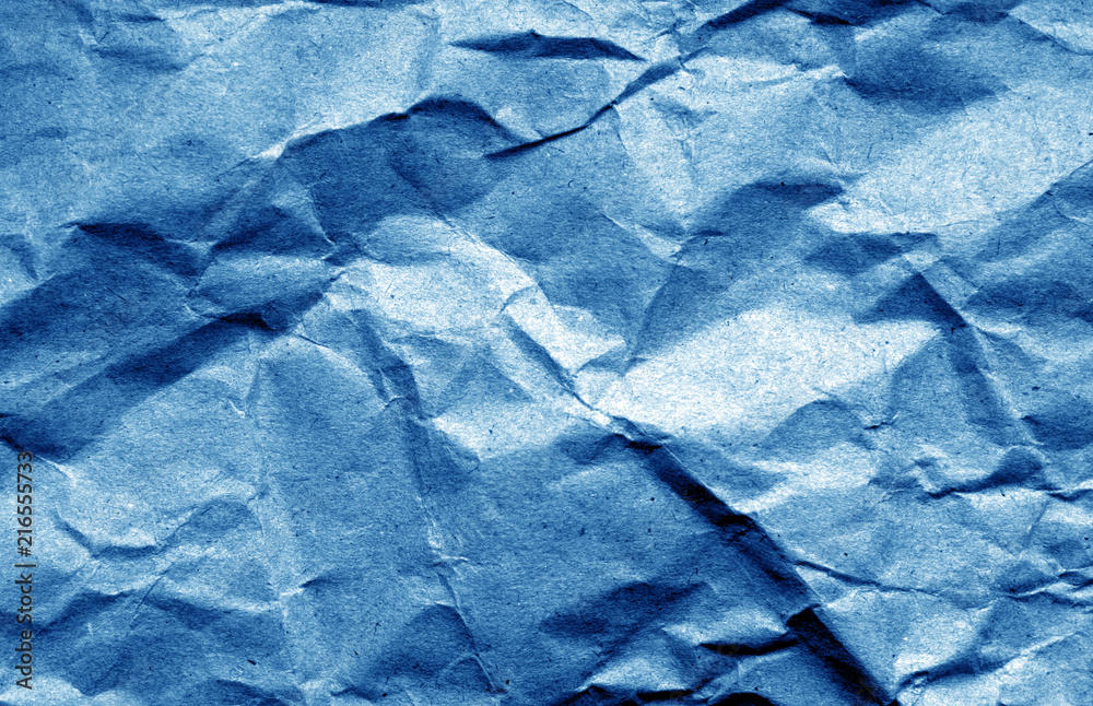 Obraz premium Old crumpled paper with wrinckles in navy blue color.