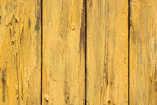 Yellow color old grunge wooden fence pattern.