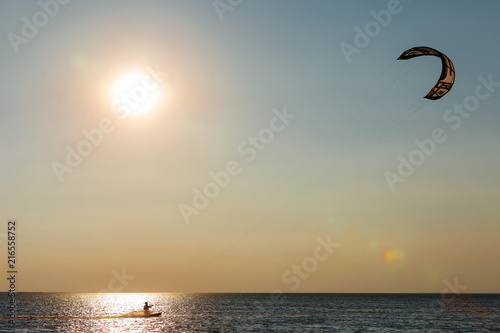 professional kiter doing a complicated trick on a beautiful sunset background © viktoriia1974