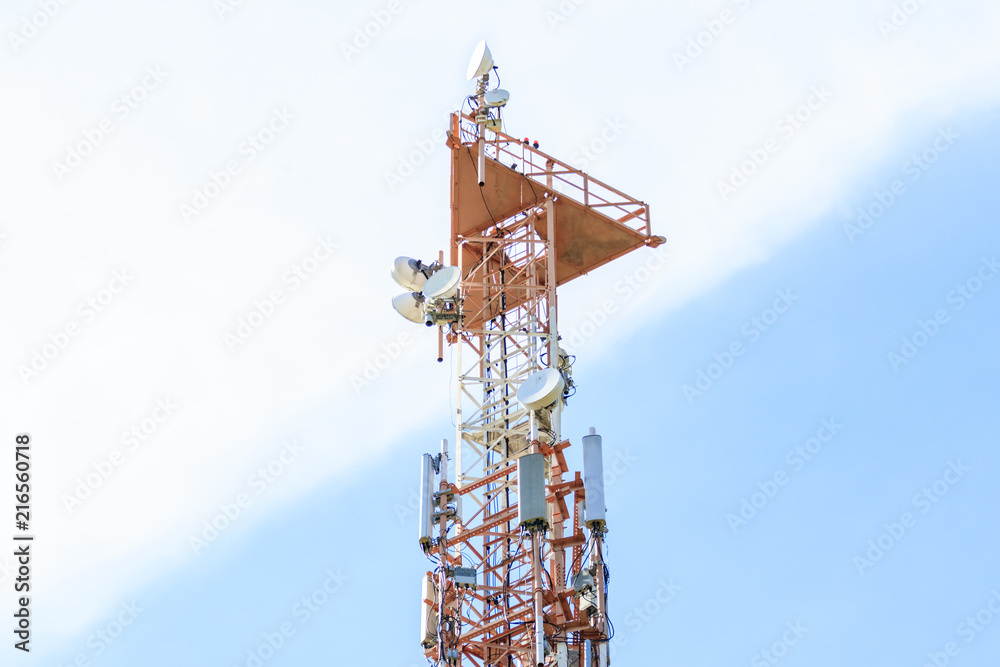 Cellular telecommunication tower and radio, blue and cloudy sky background Cellular telecommunication tower and radio, blue and cloudy sky background