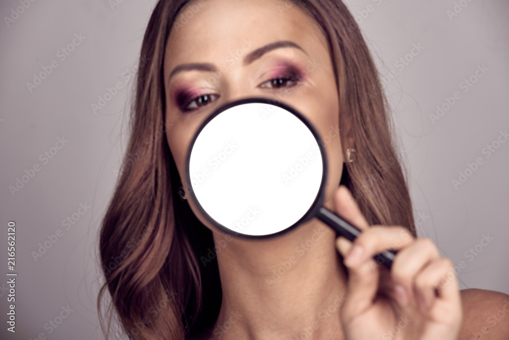 Beautiful woman with magnifying glass near mouth with copy space Beautiful woman with magnifying glass near mouth with copy space