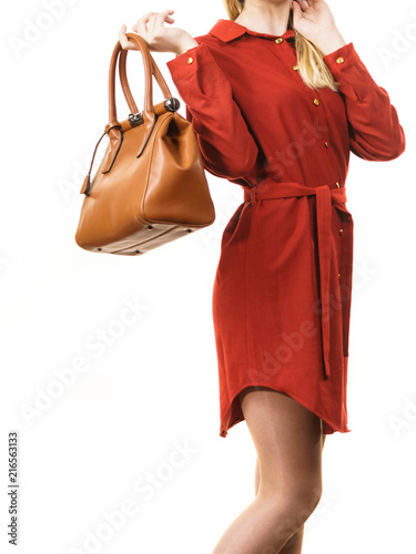 Female wearing red dress holding bag