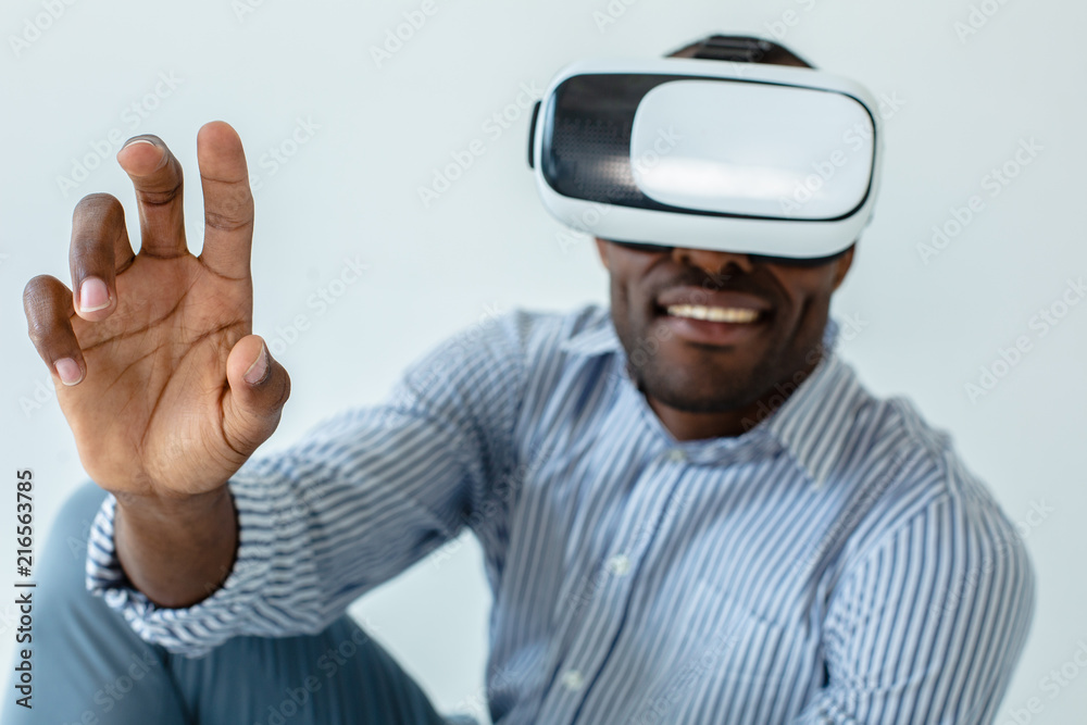 Close up of cheerful man using VR glasses Close up of cheerful man using VR glasses
